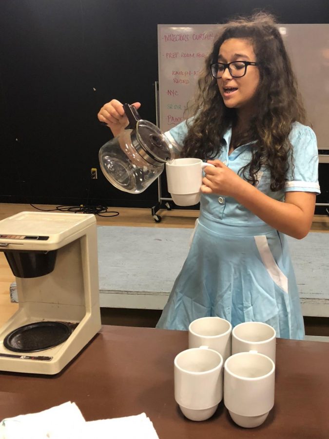 Singing as she pours coffee, sophomore Sydney Alvarez rehearses for I Dreamed a Dream.   This is one of the three student directs productions.