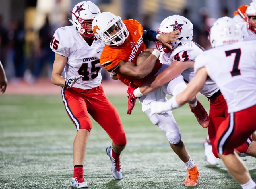 Sophomore Jordan Nabors attempts to break a tackle in the first game of the season against Coppell.  Nabors rushed for 40 yards on six carries.