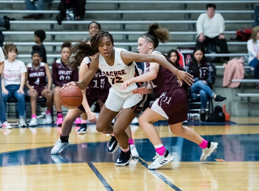 Senior Tia Harvey evades her opponent in the game against Rowlett. Harvey had 10 points in the game.