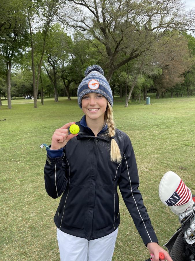 Sophomore+Ally+Cheek+displays+her+hole-in-one+ball.