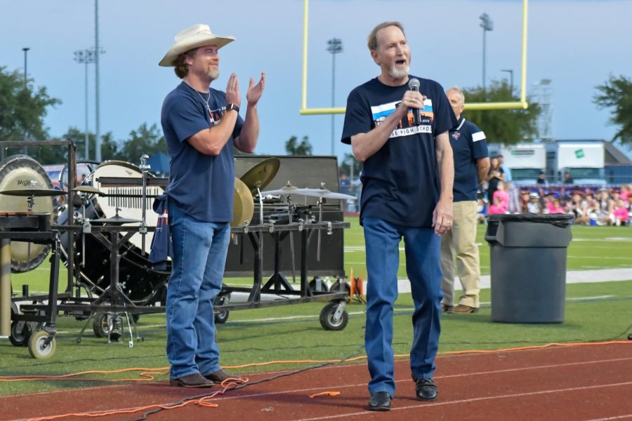 Principal Shae Creel and Steve Hammerle, the first SHS principal, get the crowd pumped up at the community homecoming pep rally