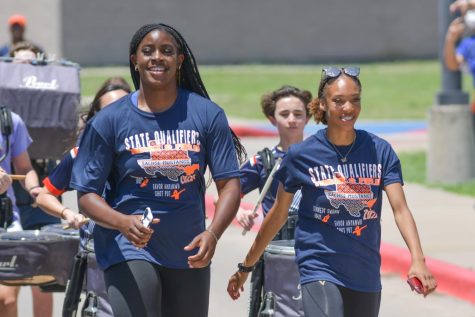 Sophomore Favor Anyanwu and senior Kennedy Swann are cheered on by the student body at the send off honoring their accomplishments as the first female track athletes to make it to the state track meet.