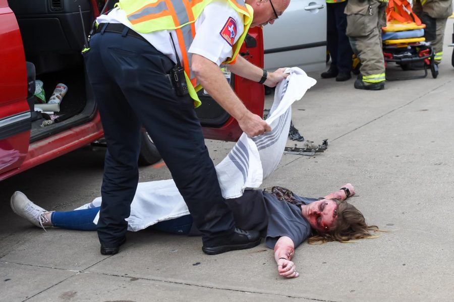 Senior Hannah Bergstrom played a casualty of the accident.  A Sachse Fire and Rescue team member covers her body.