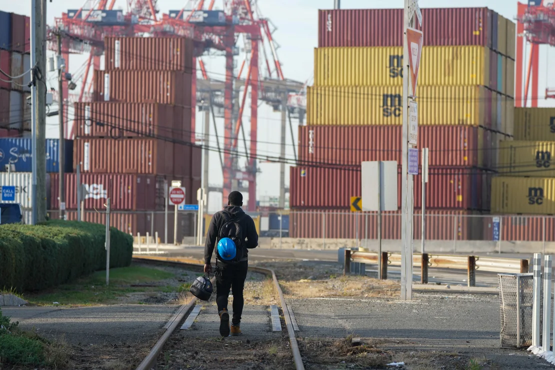 A man walks along the railroad tracks at Port Newark in New Jersey, on October 4, 2024.